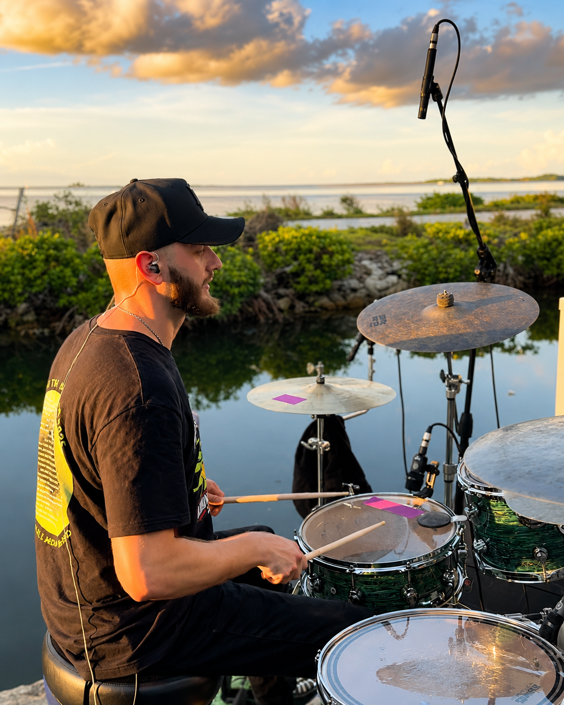 Guitarist performing at Tonio's Seafood Shack — white panama hat, acoustic guitar, tips jar