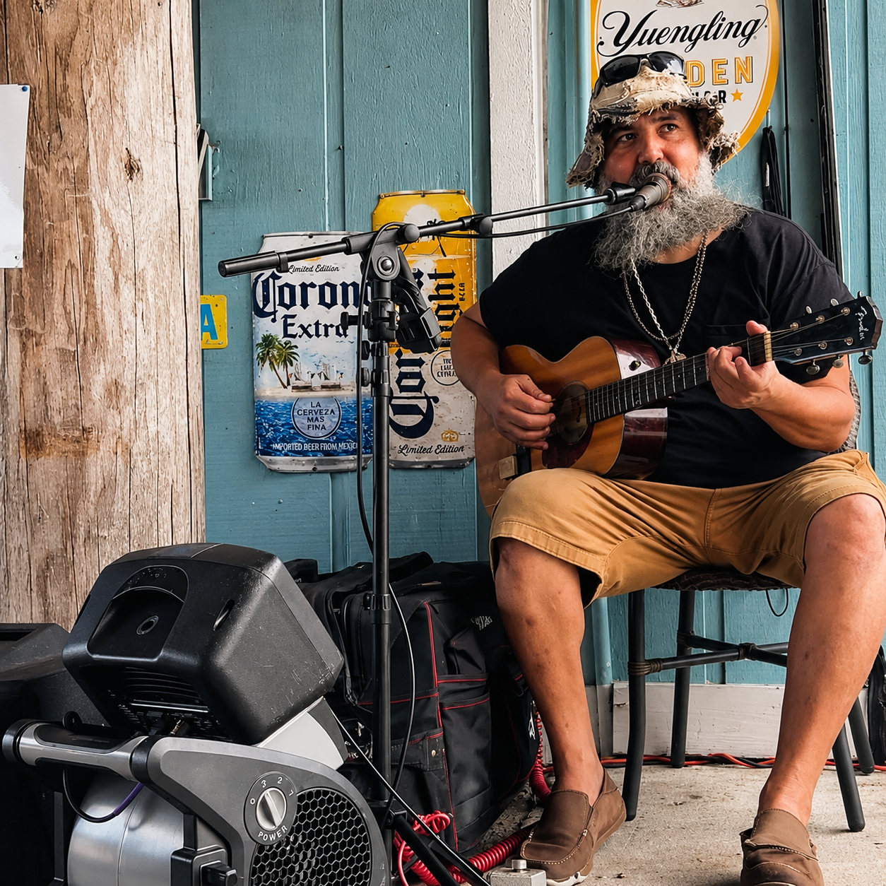 Bearded guitarist playing acoustic at Tonio's outdoor stage